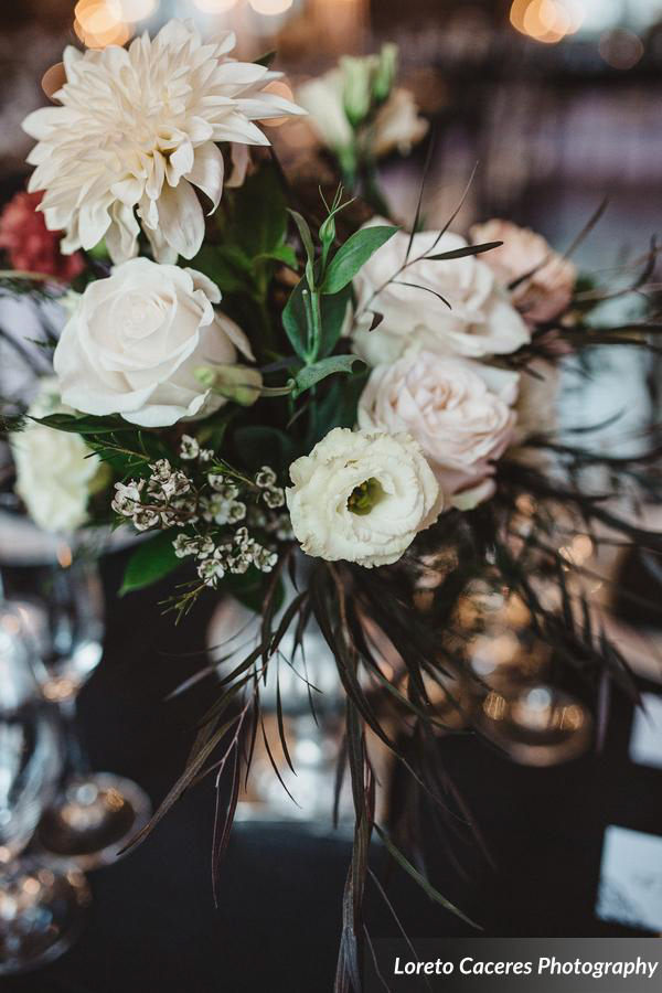Flowers in a silver urn, roses and dahlias.