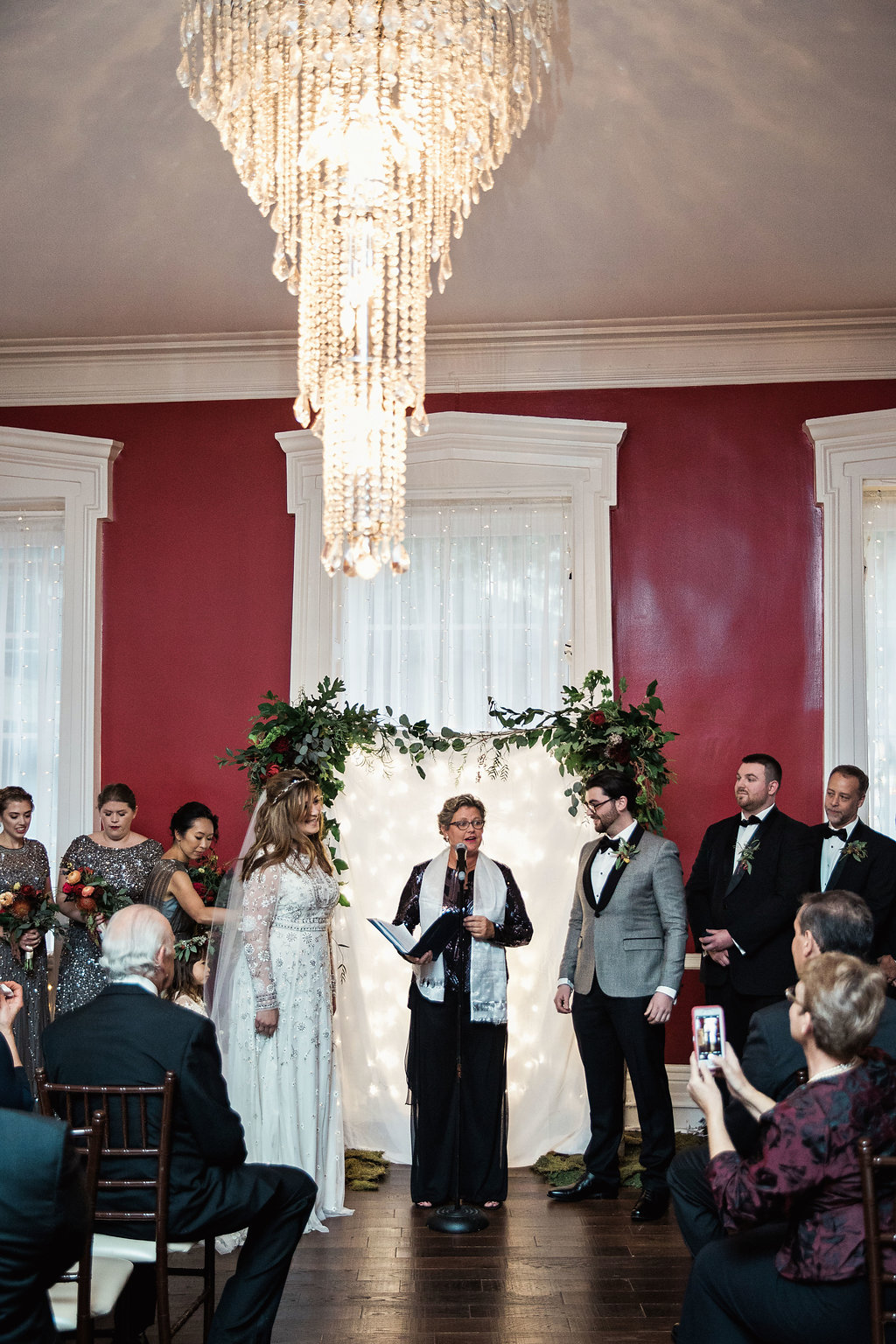 Ceremony at India House in NYC in a red room with chandelier